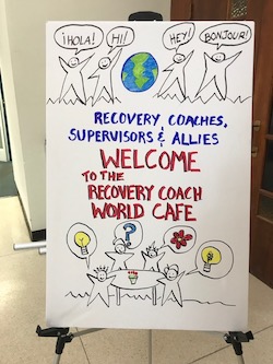 handwritten sign about a recovery world cafe